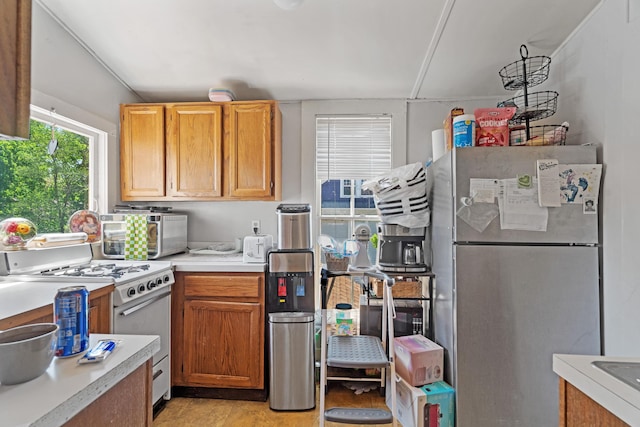 447 W Vine St, Kalamazoo, MI 49001 - kitchen featuring freestanding refrigerator, white range with gas stovetop, and light countertops