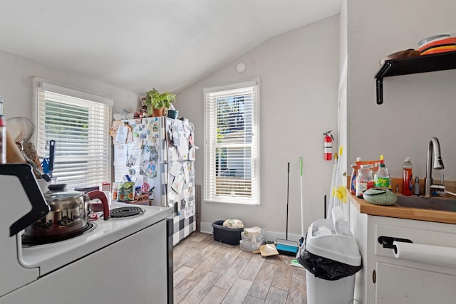 447 W Vine St, Kalamazoo, MI 49001 - kitchen with lofted ceiling, light wood-style flooring, white electric range oven, healthy amount of natural light, and white cabinetry