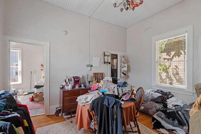447 W Vine St, Kalamazoo, MI 49001 - bedroom featuring light wood-type flooring, lofted ceiling, and a chandelier
