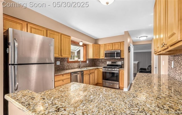 29313 Perth St, Livonia, MI 48154 - kitchen featuring appliances with stainless steel finishes, a sink, tasteful backsplash, and light stone counters