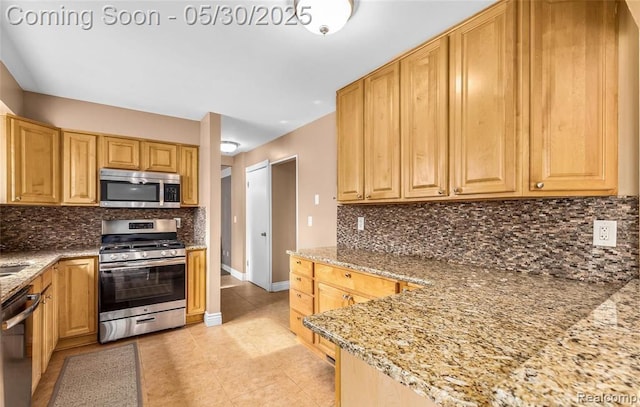 29313 Perth St, Livonia, MI 48154 - kitchen with stainless steel appliances, light stone countertops, baseboards, backsplash, and light tile patterned flooring