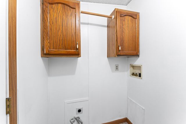25 Hunters Rill, Lapeer, MI 48446 - laundry area with cabinet space, electric dryer hookup, hookup for a washing machine, and baseboards