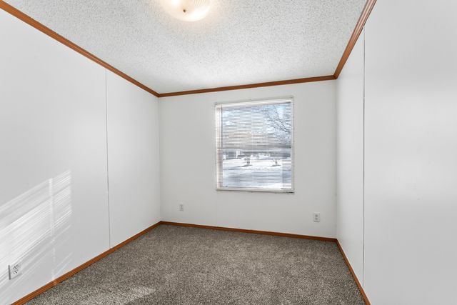 25 Hunters Rill, Lapeer, MI 48446 - empty room featuring crown molding, carpet flooring, a textured ceiling, and baseboards