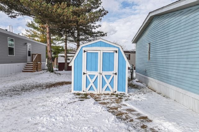 25 Hunters Rill, Lapeer, MI 48446 - snow covered structure featuring a storage unit and an outdoor structure