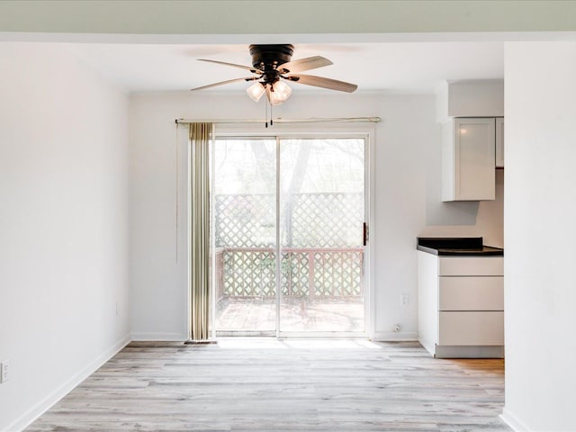 5943 Avalon Cir, Lexington, MI 48450 - unfurnished dining area with ceiling fan, light wood-type flooring, and baseboards