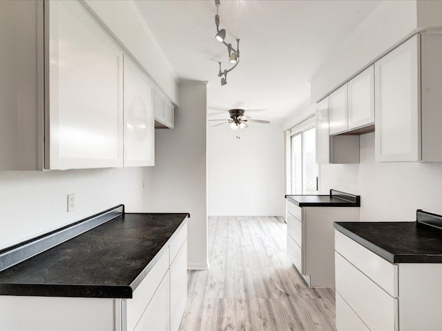 5943 Avalon Cir, Lexington, MI 48450 - kitchen with a ceiling fan, dark countertops, white cabinetry, light wood-style flooring, and rail lighting