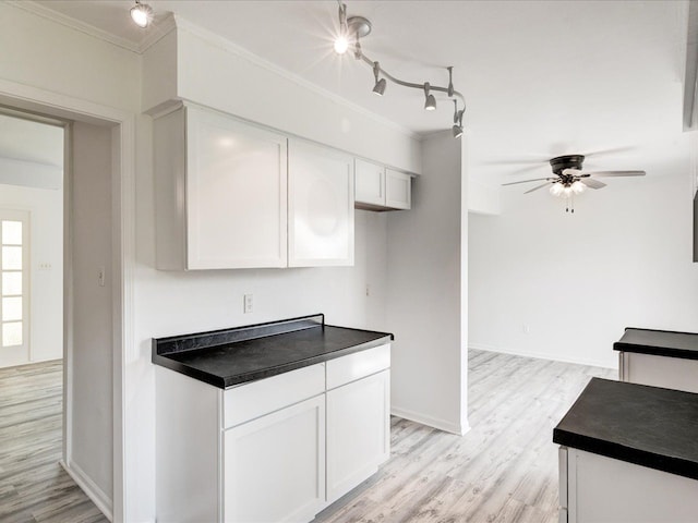 5943 Avalon Cir, Lexington, MI 48450 - kitchen featuring ornamental molding, dark countertops, a ceiling fan, white cabinetry, and light wood-type flooring