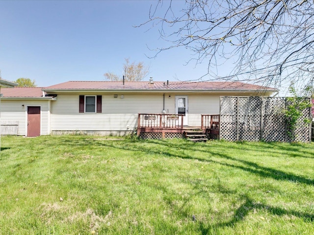 5943 Avalon Cir, Lexington, MI 48450 - rear view of house with a wooden deck, a lawn, and metal roof