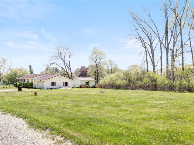 5943 Avalon Cir, Lexington, MI 48450 - view of green lawn with an attached garage