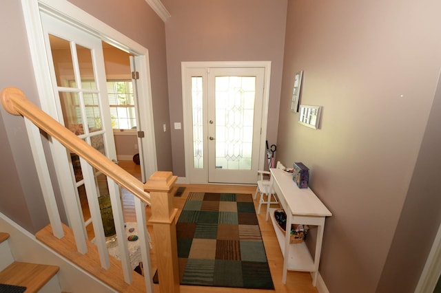 722 Bennington St, East Tawas, MI 48730 - foyer entrance with stairs, wood finished floors, and baseboards