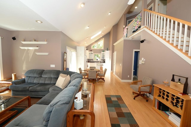 722 Bennington St, East Tawas, MI 48730 - living room with light wood-style flooring, stairs, recessed lighting, and high vaulted ceiling