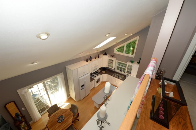 722 Bennington St, East Tawas, MI 48730 - living room featuring a skylight, light wood-type flooring, lofted ceiling, and recessed lighting