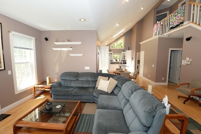 722 Bennington St, East Tawas, MI 48730 - living room with wood finished floors, baseboards, recessed lighting, and high vaulted ceiling