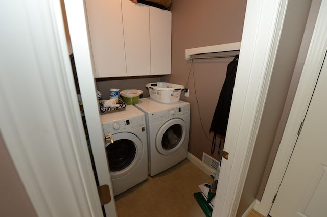 722 Bennington St, East Tawas, MI 48730 - washroom with washing machine and clothes dryer and cabinet space