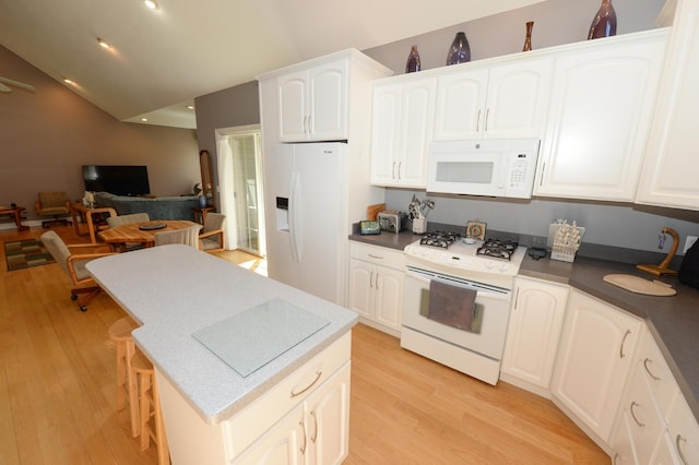 722 Bennington St, East Tawas, MI 48730 - kitchen featuring white appliances, light wood-style floors, a center island, white cabinets, and open floor plan