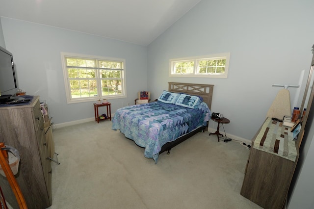 722 Bennington St, East Tawas, MI 48730 - bedroom featuring baseboards, light colored carpet, and high vaulted ceiling