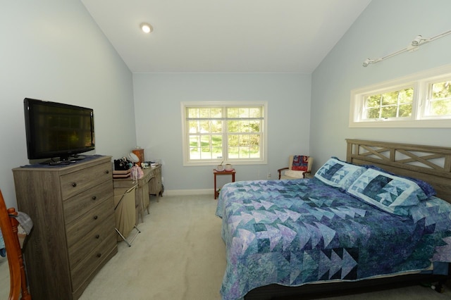 722 Bennington St, East Tawas, MI 48730 - bedroom with light carpet, vaulted ceiling, multiple windows, and baseboards