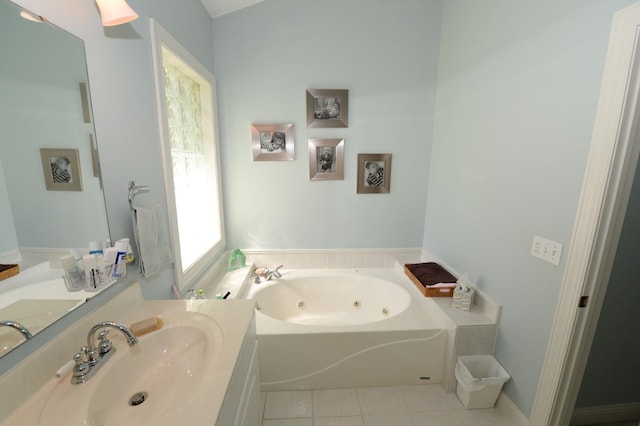 722 Bennington St, East Tawas, MI 48730 - bathroom with a jetted tub, vanity, and tile patterned floors