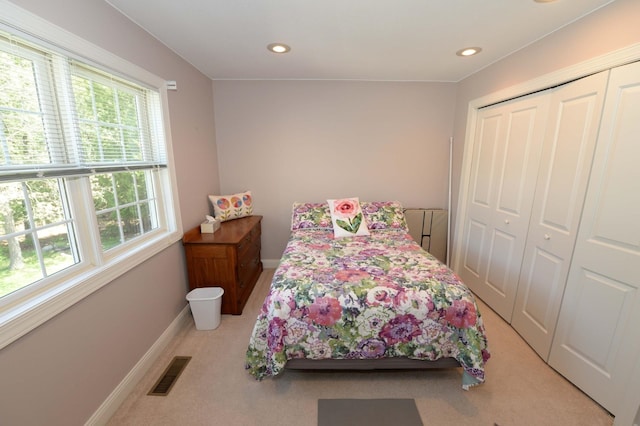 722 Bennington St, East Tawas, MI 48730 - bedroom featuring light colored carpet, baseboards, a closet, and recessed lighting