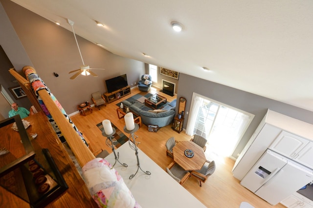722 Bennington St, East Tawas, MI 48730 - living room featuring wood finished floors, lofted ceiling, and a ceiling fan