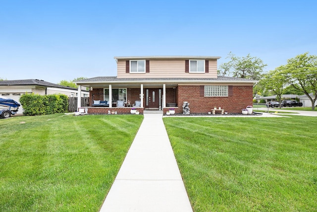 view of front of property featuring a porch, brick siding, and a front lawn