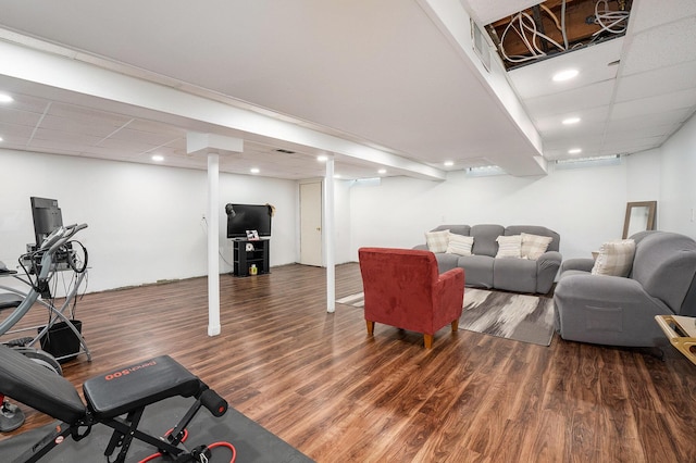 living room with wood finished floors, a paneled ceiling, and recessed lighting