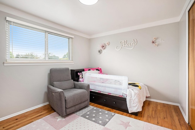 bedroom featuring baseboards and wood finished floors