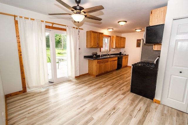 789 W Castle Rd, Fostoria, MI 48435 - kitchen featuring range with gas stovetop, brown cabinets, dark countertops, a ceiling fan, and dishwasher