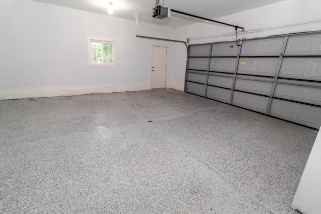789 W Castle Rd, Fostoria, MI 48435 - garage featuring a garage door opener and baseboards