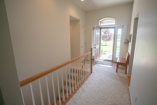 1820 Elk Ct, Owosso, MI 48867 - corridor featuring an upstairs landing, light colored carpet, and a high ceiling