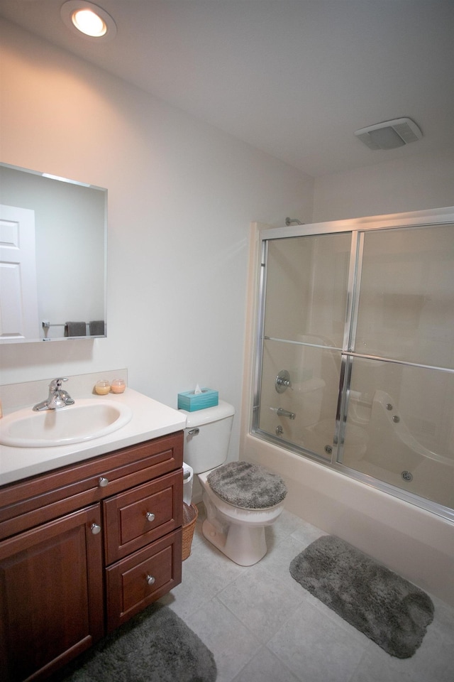 1820 Elk Ct, Owosso, MI 48867 - full bath with tile patterned flooring, combined bath / shower with glass door, vanity, and toilet