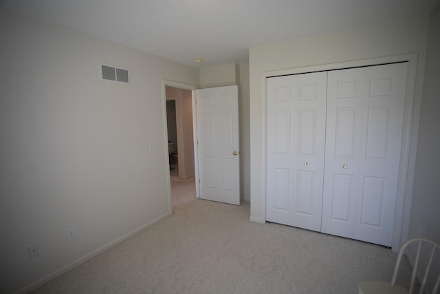 1820 Elk Ct, Owosso, MI 48867 - unfurnished bedroom with light colored carpet, baseboards, and a closet