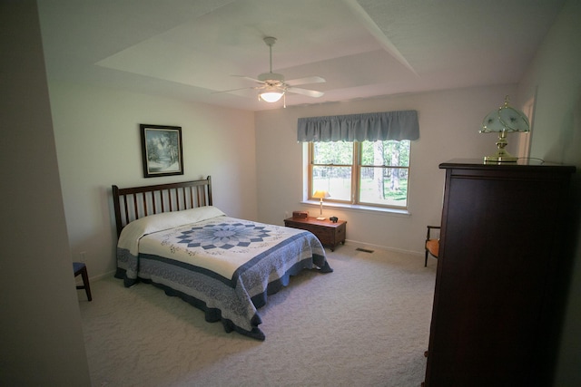 1820 Elk Ct, Owosso, MI 48867 - carpeted bedroom featuring a tray ceiling, baseboards, and a ceiling fan