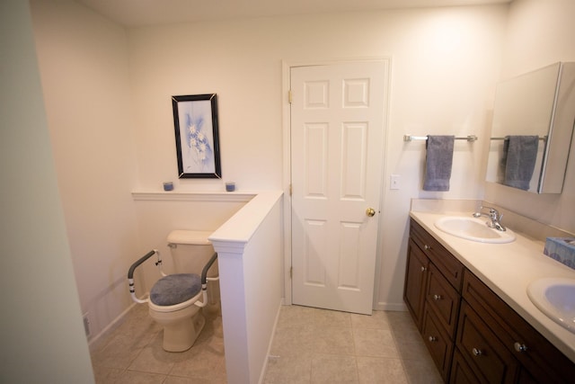 1820 Elk Ct, Owosso, MI 48867 - full bathroom featuring toilet, tile patterned floors, double vanity, and baseboards