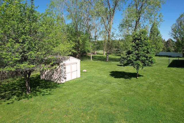 1820 Elk Ct, Owosso, MI 48867 - view of green lawn with a storage unit and an outbuilding