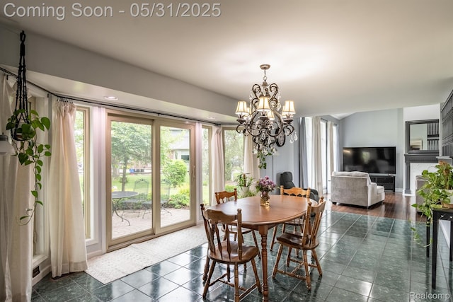 42739 Pond View Dr, Sterling Heights, MI 48314 - dining space with a chandelier and dark tile patterned flooring