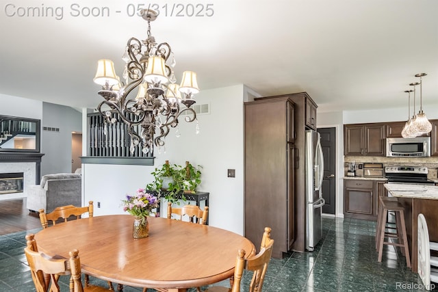 42739 Pond View Dr, Sterling Heights, MI 48314 - dining room with a chandelier and a glass covered fireplace