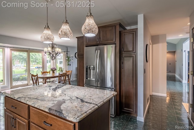 42739 Pond View Dr, Sterling Heights, MI 48314 - kitchen with stainless steel fridge, baseboards, a chandelier, a kitchen island, and light stone countertops