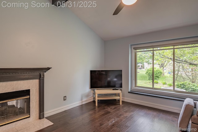 42739 Pond View Dr, Sterling Heights, MI 48314 - living area with ceiling fan, vaulted ceiling, dark wood-style floors, baseboards, and a tiled fireplace