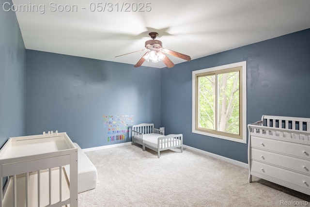 42739 Pond View Dr, Sterling Heights, MI 48314 - carpeted bedroom featuring a nursery area, baseboards, and a ceiling fan