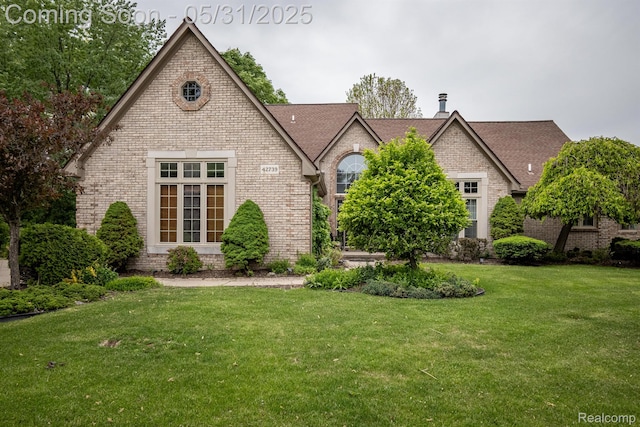 42739 Pond View Dr, Sterling Heights, MI 48314 - view of front of property featuring brick siding and a front yard