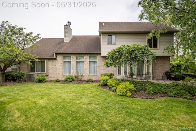 42739 Pond View Dr, Sterling Heights, MI 48314 - view of front of property with brick siding, a patio area, a front yard, a chimney, and central AC unit