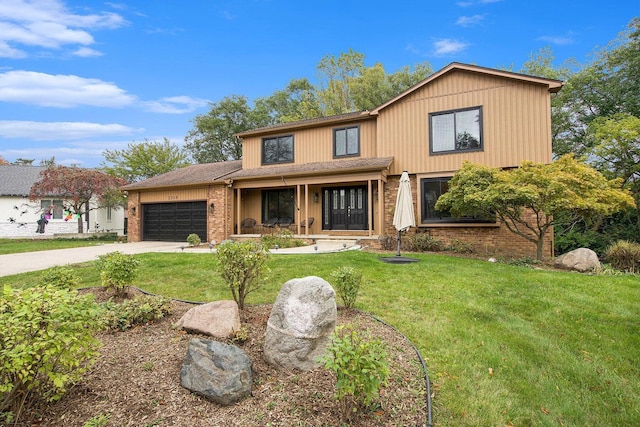 2315 Adare Rd, Ann Arbor, MI 48104 - view of front of house with an attached garage, covered porch, brick siding, concrete driveway, and a front yard
