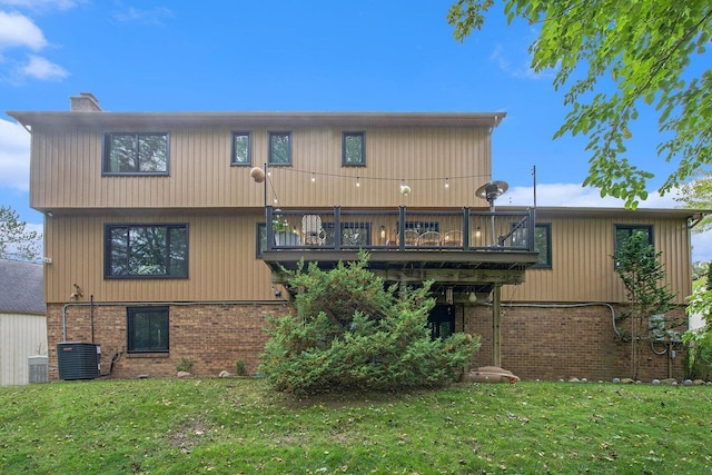 2315 Adare Rd, Ann Arbor, MI 48104 - rear view of property with brick siding, a chimney, a yard, central air condition unit, and a wooden deck