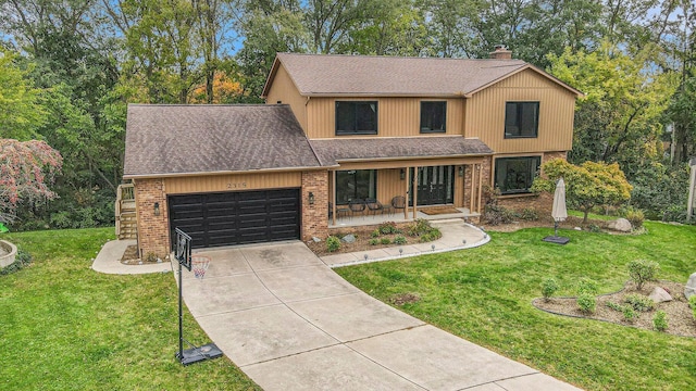 2315 Adare Rd, Ann Arbor, MI 48104 - view of front of house with roof with shingles, covered porch, an attached garage, brick siding, and driveway