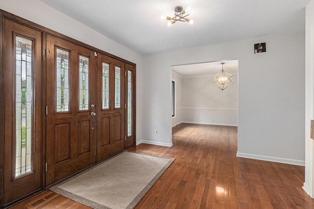 2315 Adare Rd, Ann Arbor, MI 48104 - foyer entrance featuring a chandelier, baseboards, and hardwood / wood-style flooring