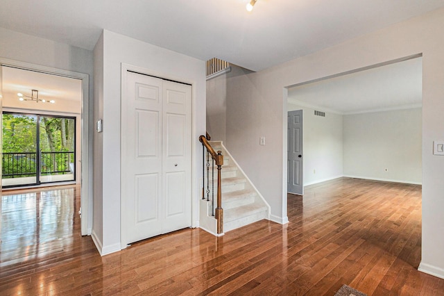 2315 Adare Rd, Ann Arbor, MI 48104 - empty room with wood-type flooring, stairway, baseboards, and ornamental molding