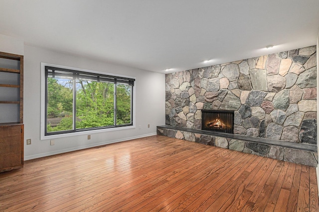 2315 Adare Rd, Ann Arbor, MI 48104 - unfurnished living room with hardwood / wood-style flooring, a fireplace, and baseboards