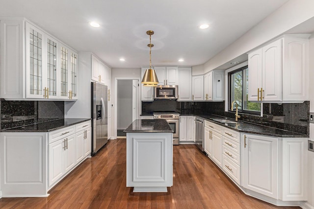2315 Adare Rd, Ann Arbor, MI 48104 - kitchen with appliances with stainless steel finishes, a sink, white cabinetry, a center island, and recessed lighting
