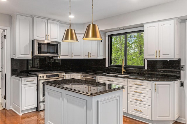 2315 Adare Rd, Ann Arbor, MI 48104 - kitchen with appliances with stainless steel finishes, a sink, decorative backsplash, white cabinets, and recessed lighting